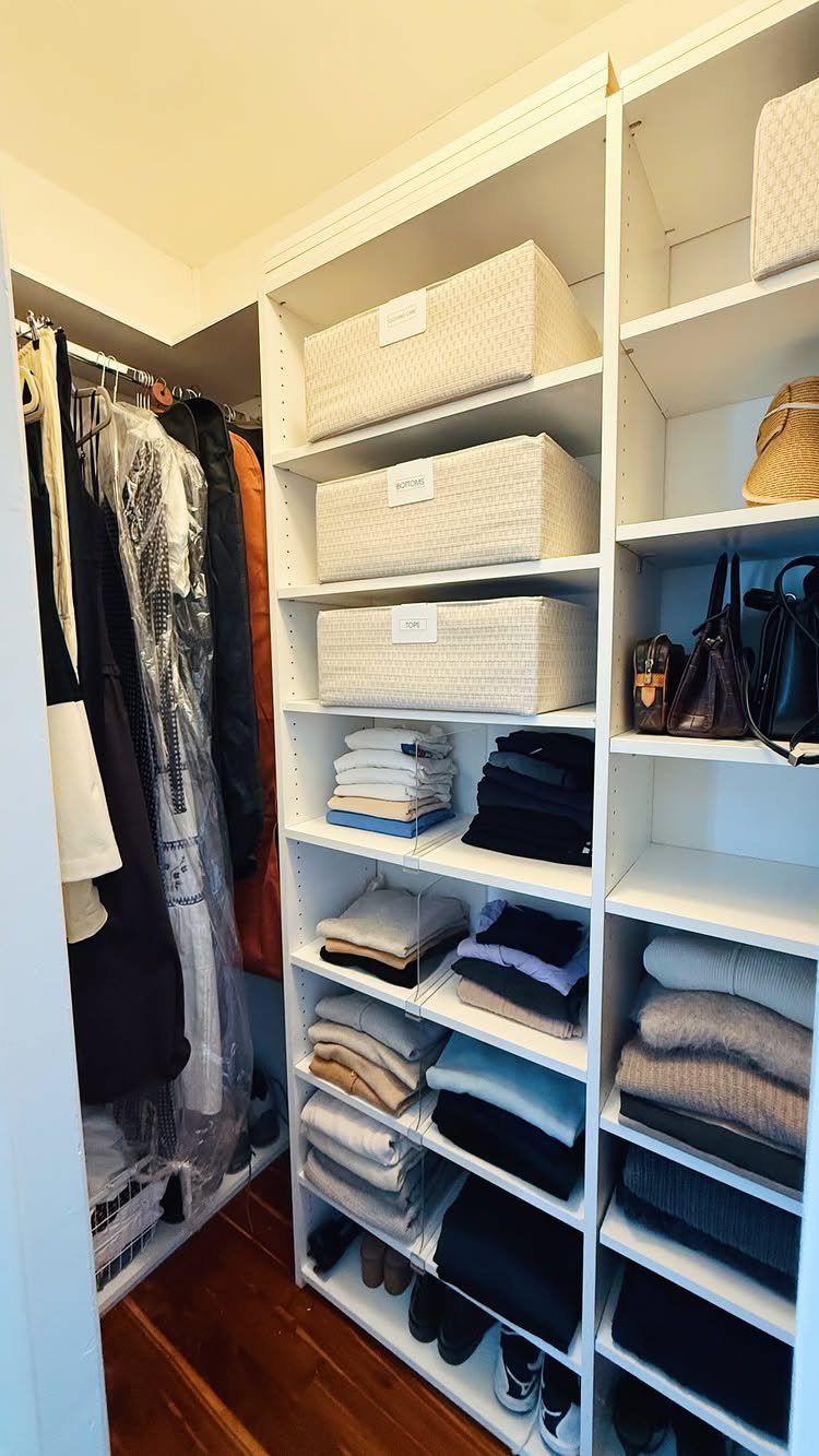 Closet Organization: 8 Sweater Storage Ideas That Save Space 6 White closet shelves containing folded sweaters and white fabric storage bins organized neatly.