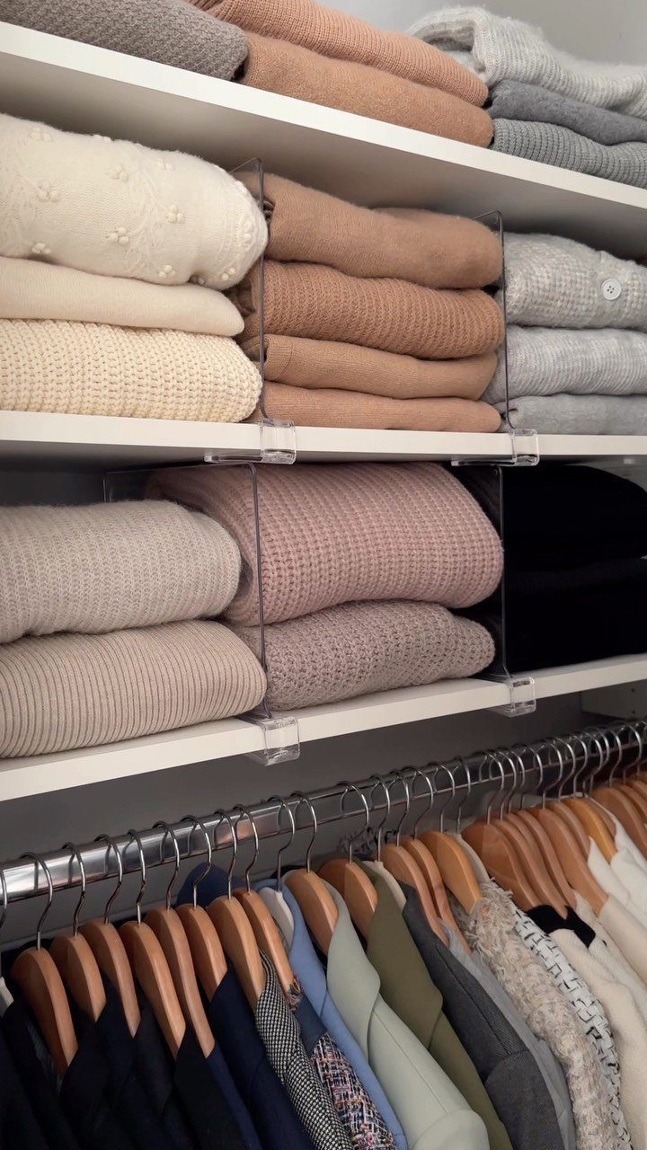 Closet Organization: 8 Sweater Storage Ideas That Save Space 4 Folded neutral sweaters organized on white shelves with clear acrylic dividers in a closet.
