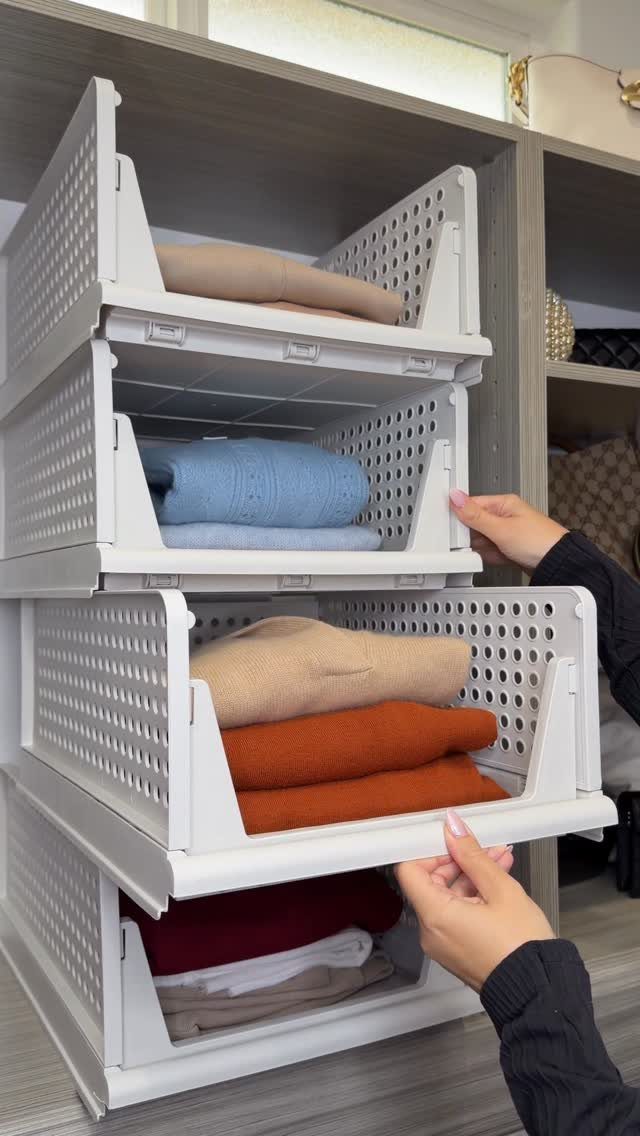 Closet Organization: 8 Sweater Storage Ideas That Save Space 8 Hands pulling a white drawer containing folded colorful sweaters from a grey closet organizer.