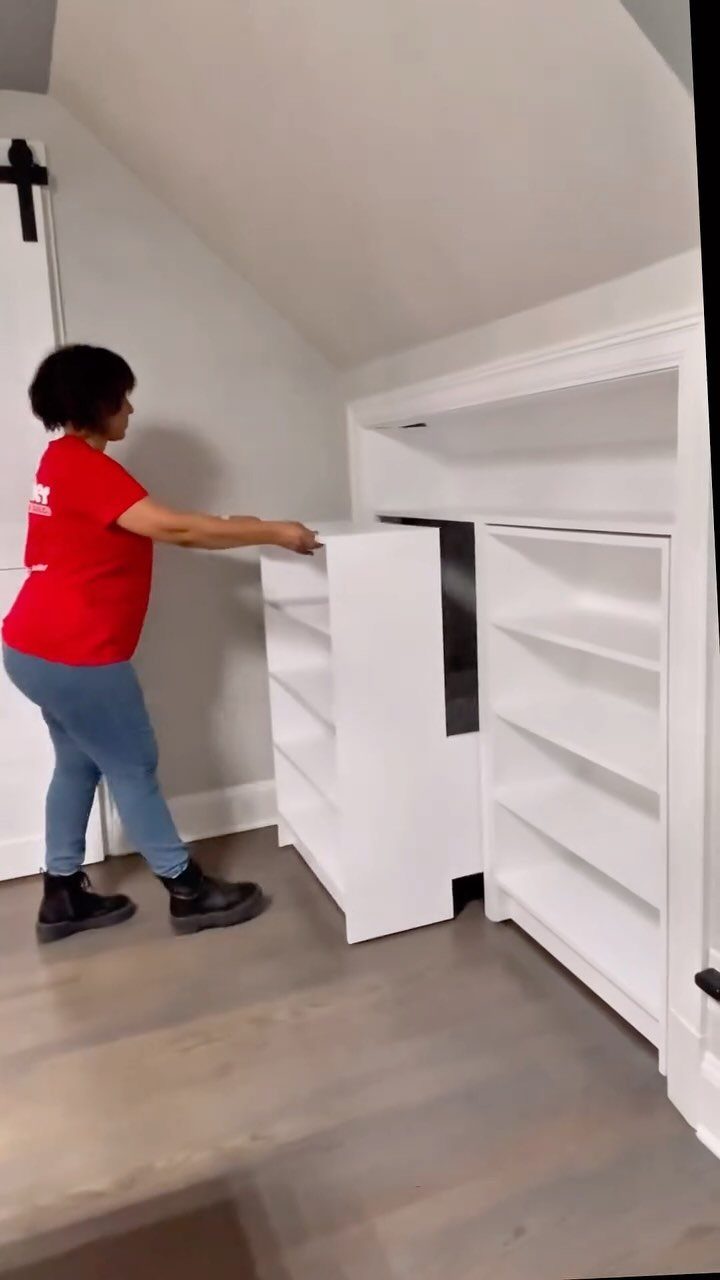 5 Creative Hidden Toy Storage Solutions to Reclaim Your Space 5 A woman pulls a white tiered storage unit out from a built-in white cabinet.