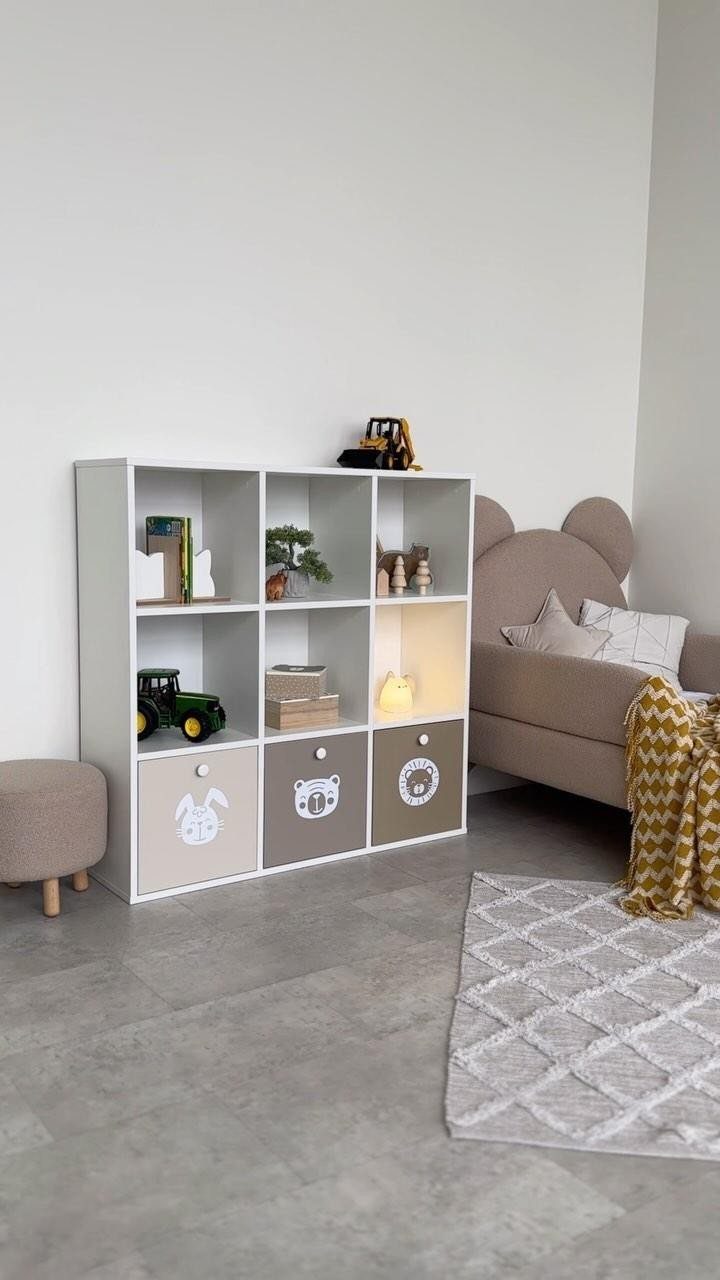 5 Creative Hidden Toy Storage Solutions to Reclaim Your Space 2 White toy cubby shelving unit with animal-themed storage bins in a child's bedroom.