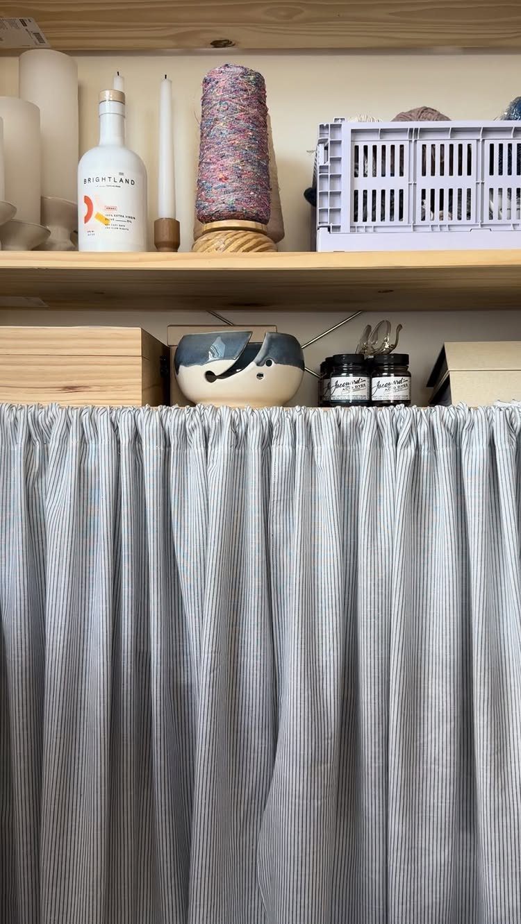 11 Curtain Closet Ideas for Style and Space 8 Blue and white striped fabric curtains hanging from a wooden shelf in a room.