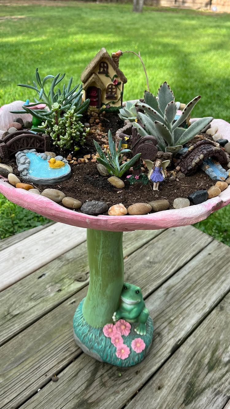 23 Fairy Garden Ideas for Tiny Houses, Teacups and Tree Trunks 22 Miniature fairy garden with a small house, succulents, and a fairy figurine on a mushroom pedestal.
