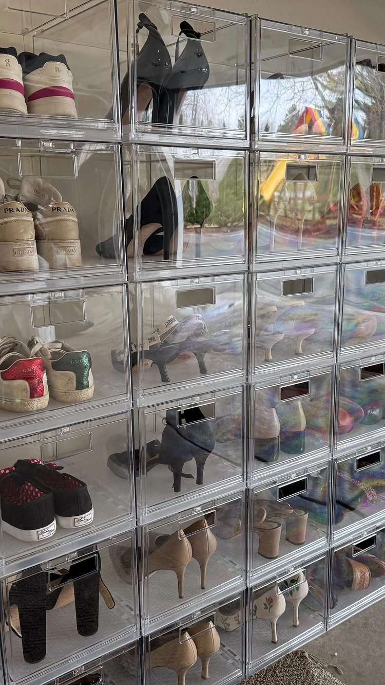 9 Garage Storage Shoes For Any Budget, Wall to Floor 6 Clear acrylic storage boxes containing various styles of women's shoes organized in a large stack.