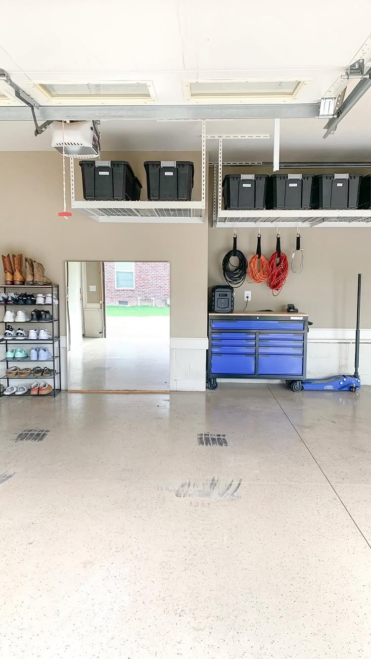 9 Garage Storage Shoes For Any Budget, Wall to Floor 2 A garage interior featuring a blue tool chest, hanging sports gear, and a black shoe rack.