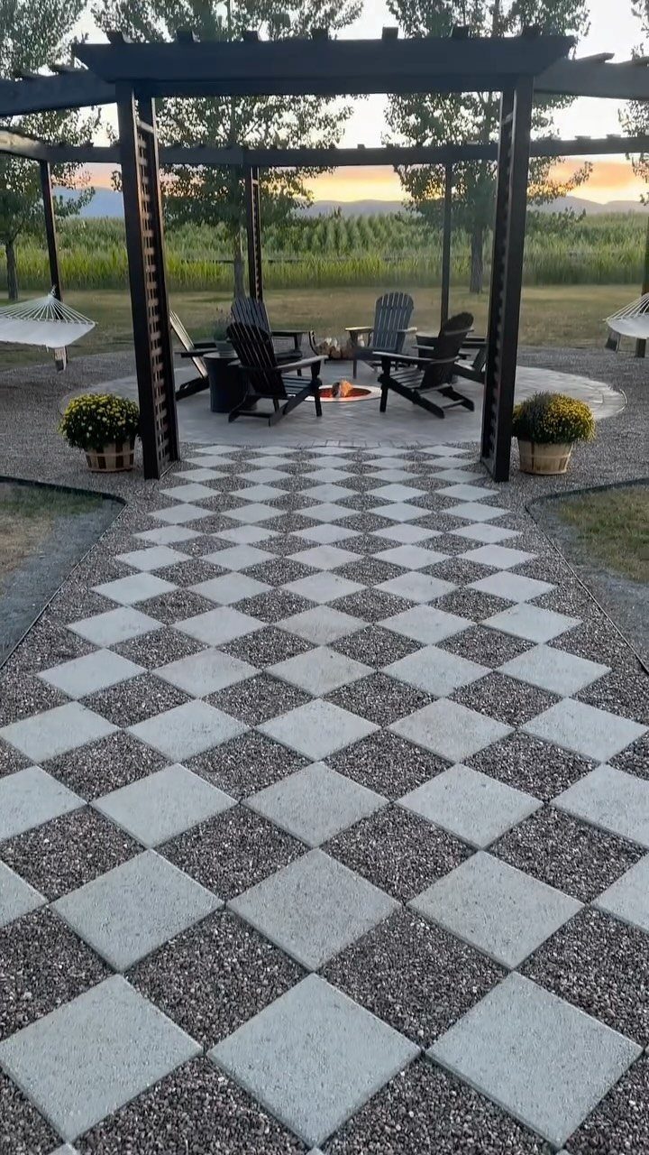 10 Garden Pathways Ideas for Gravel, Brick, Wood and Stone 8 Checkerboard garden pathway made of light grey pavers and dark gravel leading to a pergola.