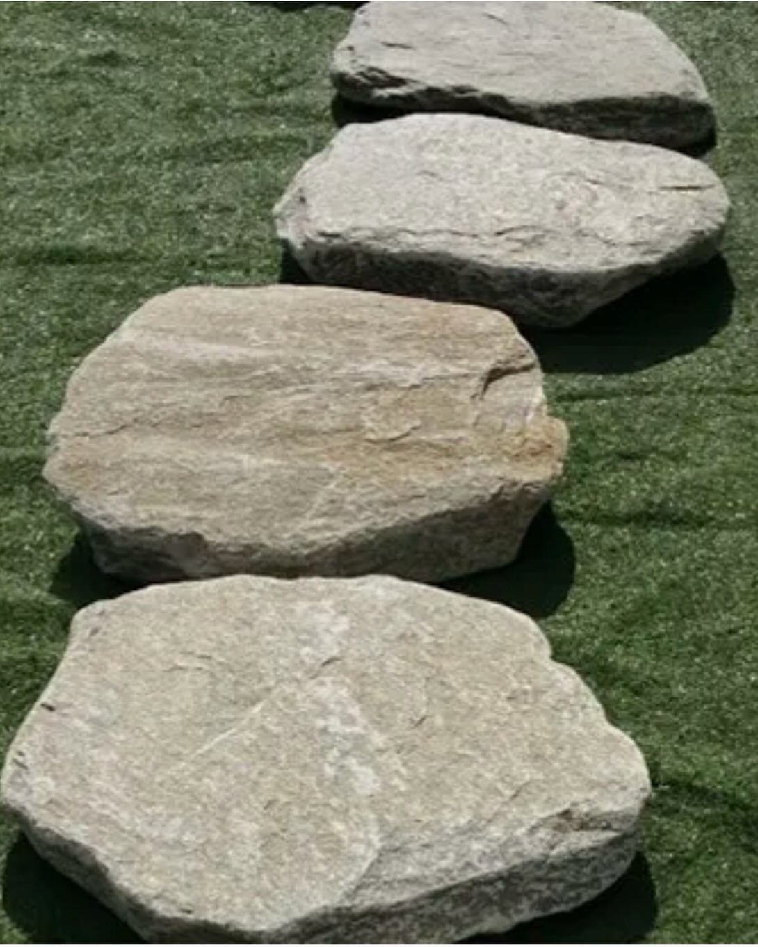 10 Garden Pathways Ideas for Gravel, Brick, Wood and Stone 2 Large flat grey stones arranged in a line across a green grass lawn.