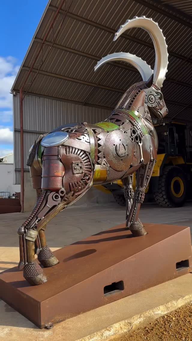 Metal Yard Art Ideas for Your Garden in 7 Styles 4 A large scrap metal sculpture of a goat made from various gears and metallic parts.