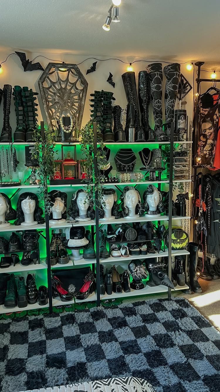 11 No Closet Room Ideas for Clothing Racks, Under-Bed Storage and More 11 Black gothic boots and accessories displayed on white shelves with green lighting and bat decorations.