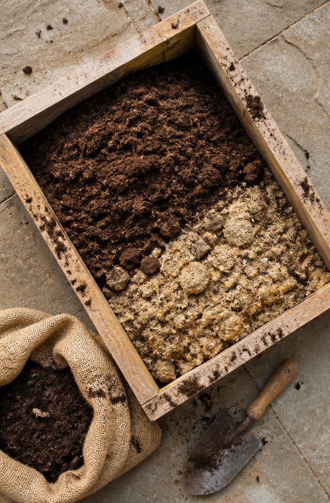 A close-up of well-mixed soil blend in a planter box garden.
