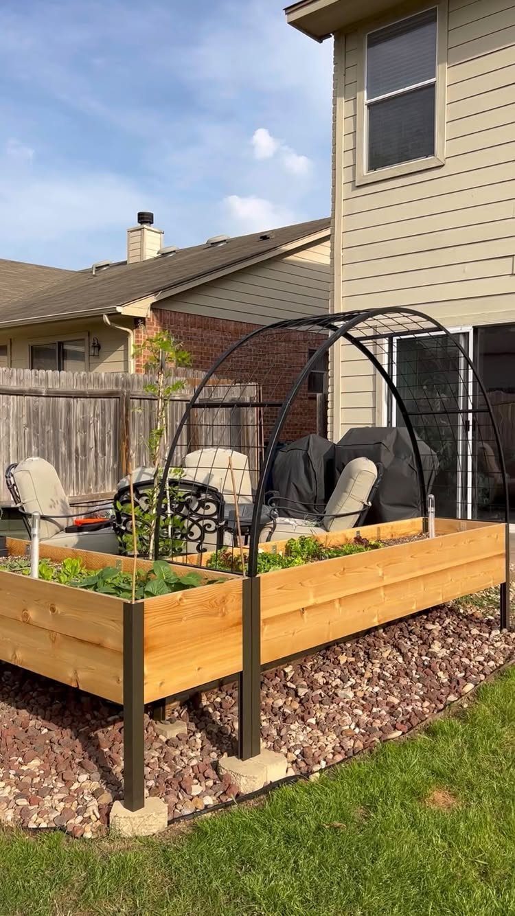 13 Planter Boxes Ideas for Your Porch, Deck and Garden 8 Wooden raised garden bed with a black metal trellis and green plants in a backyard setting.