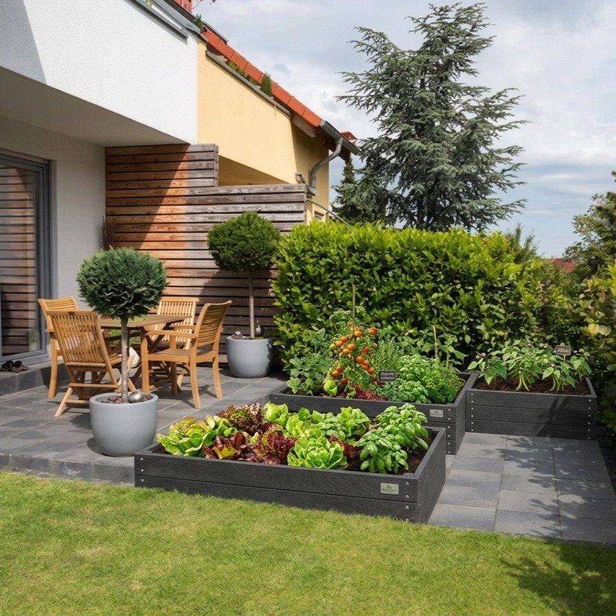 13 Planter Boxes Ideas for Your Porch, Deck and Garden 10 Dark grey rectangular raised planter boxes filled with leafy greens and tomatoes on a patio.