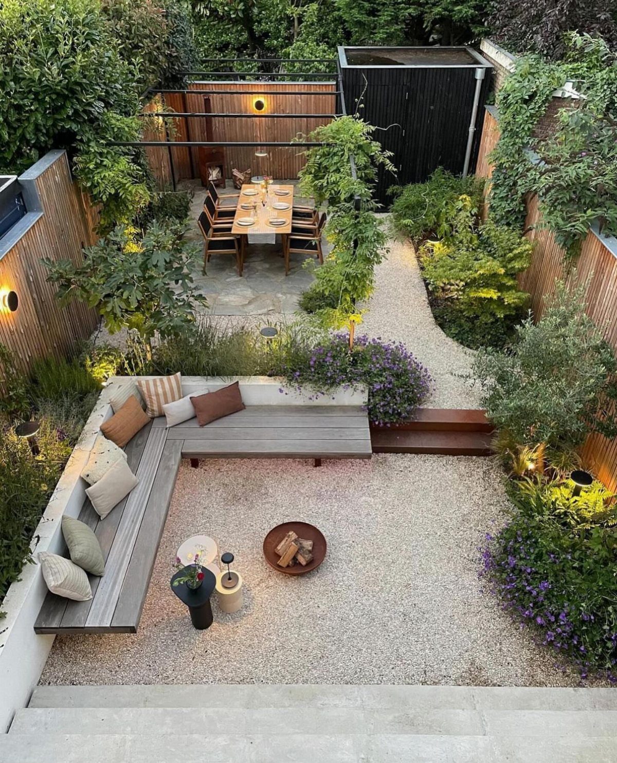 18 Small Backyard Garden Ideas for Compact Outdoor Style 8 A modern small backyard with gravel, built-in wooden seating, and a dining area surrounded by greenery.