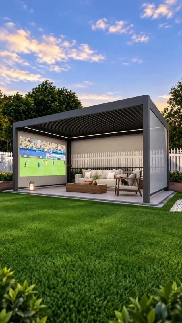 Modern grey pergola with outdoor lounge furniture and a large movie screen in a backyard.